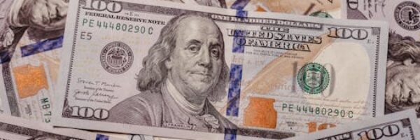 Stack of 100 dollar US banknotes with Benjamin Franklin portrait.